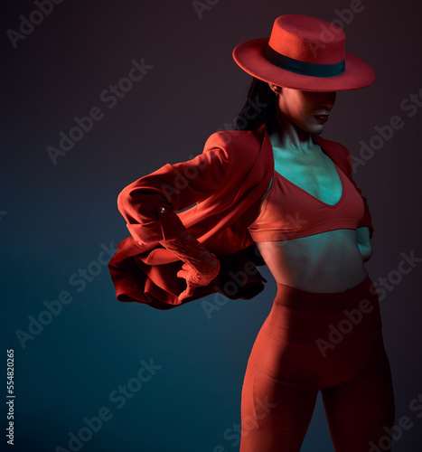 Foto Fashion, suit and woman in studio with retro, style and smart casual, edgy and creative pose on dark background mockup