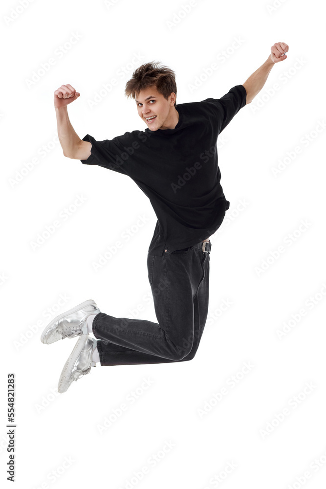 young man in black t-shirt smiling jumping high