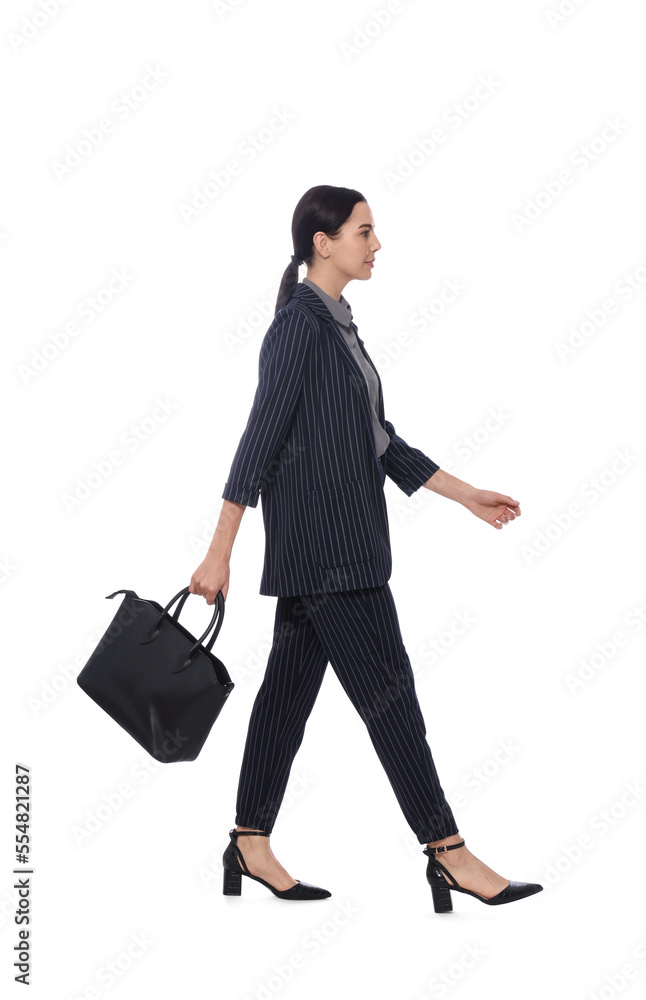 Young businesswoman with leather bag walking on white background Young businesswoman with leather bag walking on white background