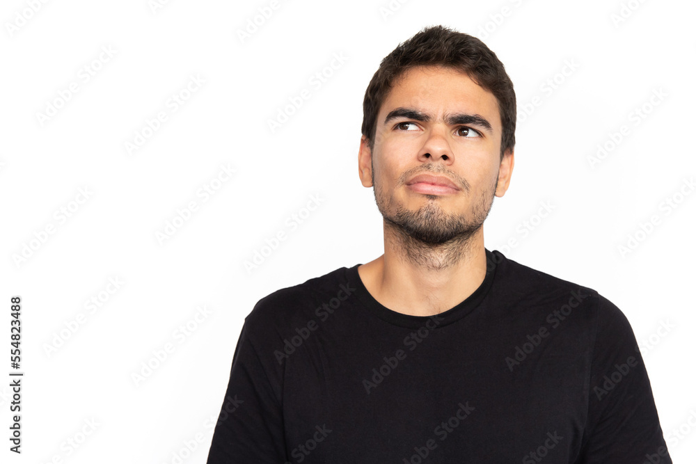 Confused young man looking away at ads. Portrait of pensive Caucasian male model with short dark hair in black T-shirt frowning, thinking or seeing something strange. Confusion, advertising concept Confused young man looking away at ads. Portrait of pensive Caucasian male model with short dark hair in black T-shirt frowning, thinking or seeing something strange. Confusion, advertising concept