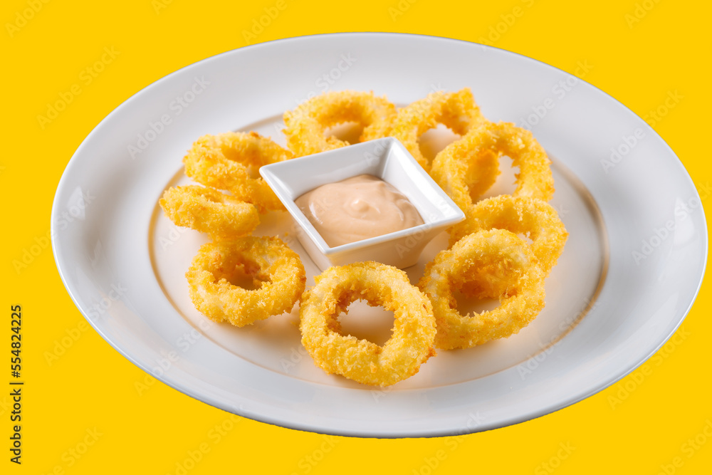 Delicious fried food, fried squid rings.on yellow background Delicious fried food, fried squid rings.on yellow background