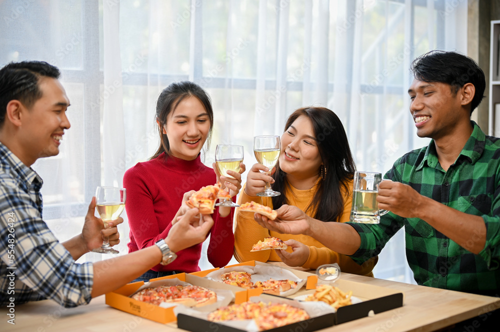 Group of diversity Asian friends drinking wine and eating pizza in the party at home