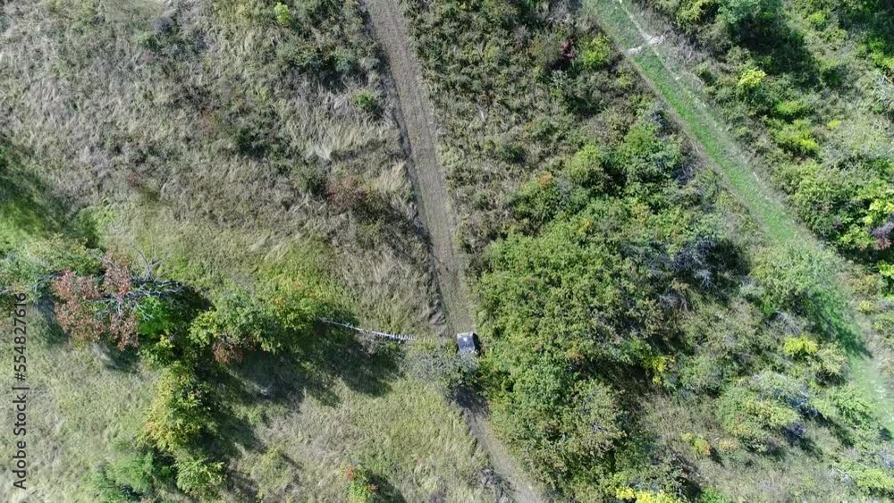 Aerial drone view of ATV quads on a dirt trail in forests. Off-road group team club enthusiasts having fun while driving countryside roads. Aerial drone view of ATV quads on a dirt trail in forests. Off-road group team club enthusiasts having fun while driving countryside roads.