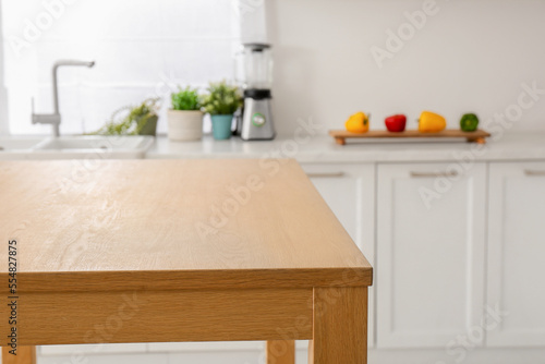 Stylish wooden table in kitchen. Interior design