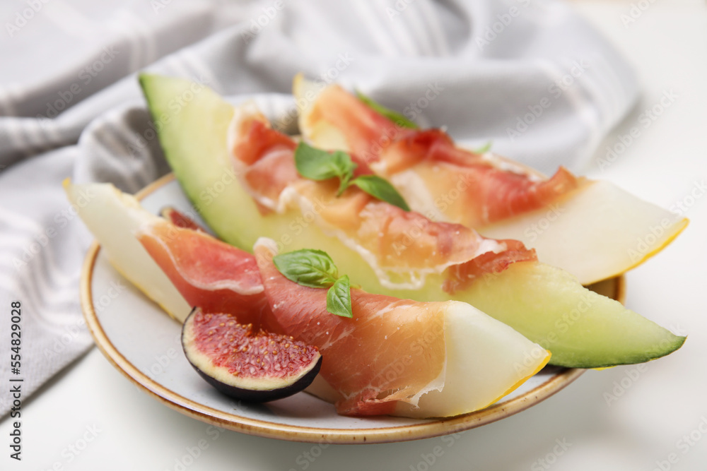 Plate of tasty melon, jamon, and figs on white table, closeup Plate of tasty melon, jamon, and figs on white table, closeup