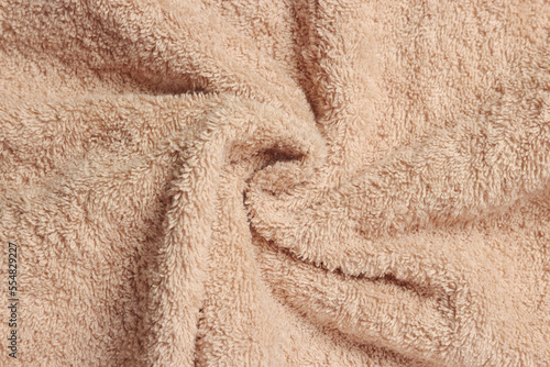 Soft crumpled beige towel as background, top view