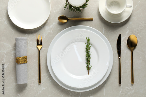 Beautiful table setting on light marble surface, flat lay