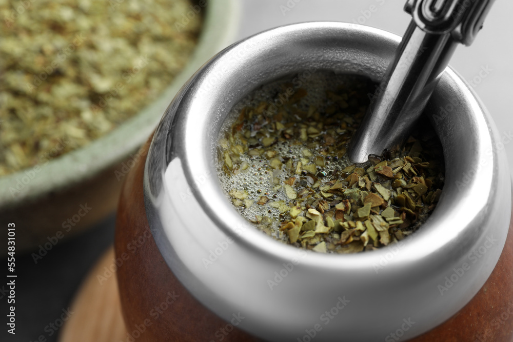 Calabash with bombilla and mate tea on table, closeup Calabash with bombilla and mate tea on table, closeup