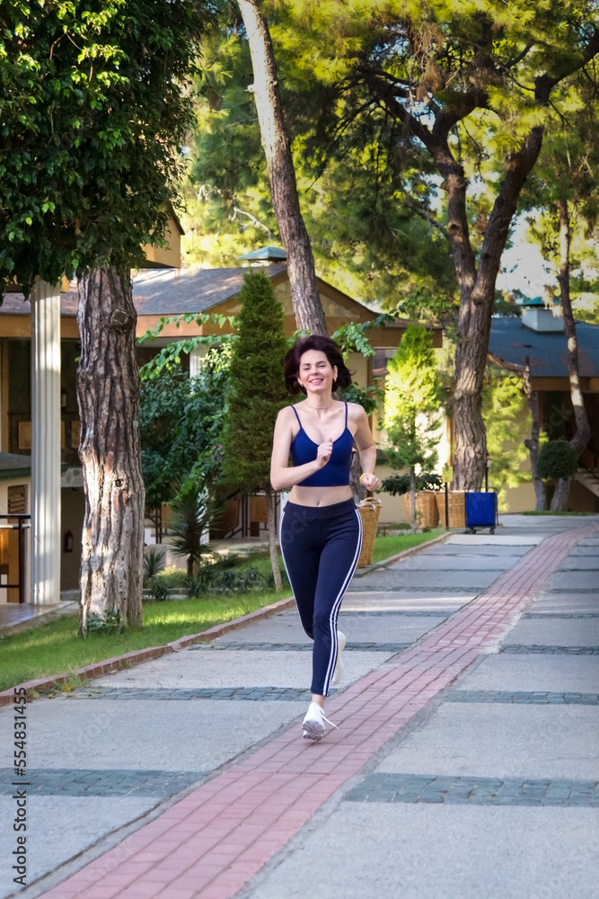 Woman running on the road made stone doing sports. Woman running on the road made stone doing sports.