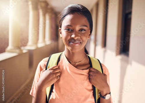 Happy, university and black woman student portrait at educational building in Chicago, USA. College campus and happiness of gen z girl outside lecture classroom with optimistic smile.