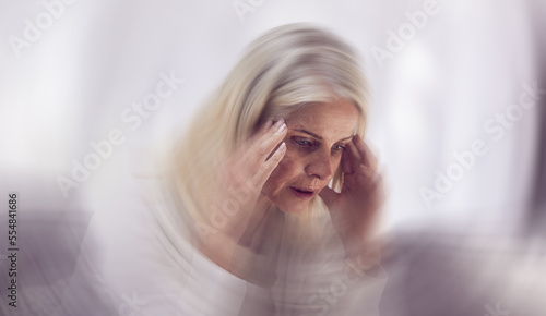 Senior woman, headache and dizzy motion blur on sofa for mental health, stress and health risk. Elderly person, tired and suffering from migraine for dementia crisis or head pain in retirement home photo