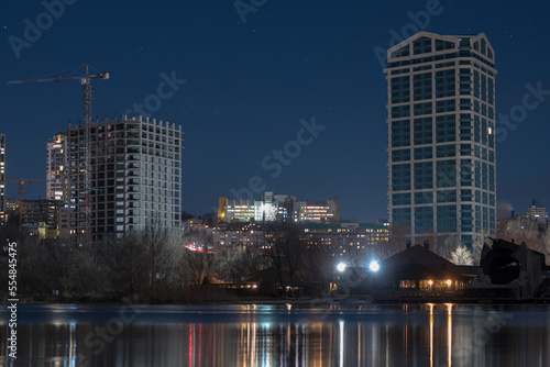 Scenic view of the city of Dnepr in the winter evening. Dnipro in the evening. Ukrainian city in winter at night. background image. Panoramic view. Long exposure photo of the Dnieper River at night.