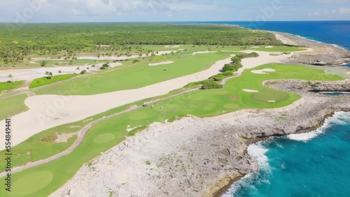 Corales Golf Course on cliffs along rocky coast, Punta Cana Resort in Dominican Republic. Aerial forward photo
