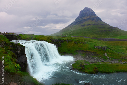 Lanscape of mountain and waterfall in cloudy sky. Famous Kirkjufelfoss cascade
