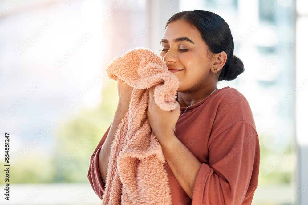 Woman smelling clean laundry, blanket or fabric for fresh and clean smell in house after doing washing, cleaning and housekeeping. Happy female cleaner with textile for aroma, fragrance and scent - obrazy, fototapety, plakaty 