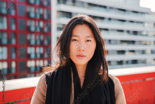 Canvas Print Front view of young stylish chinese woman looking serious at camera