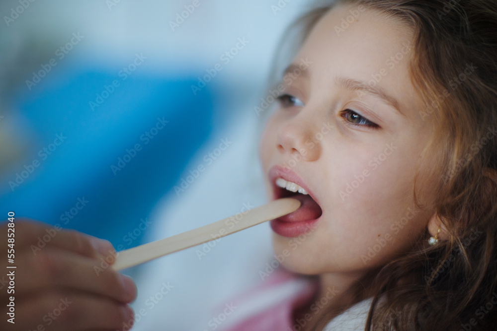 Close-up of examining little girls throat in hospital. Close-up of examining little girls throat in hospital.