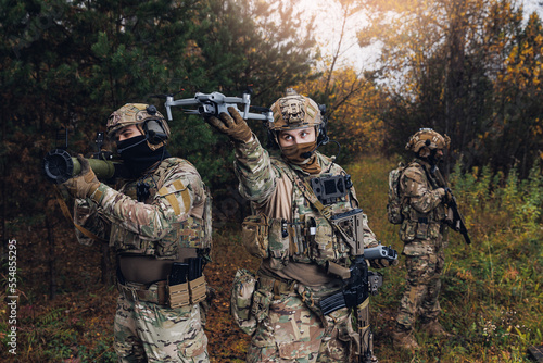 Modern soldiers team. Concept army using technology drone for war controller attack