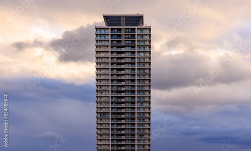 Dramatic clouds behind apartment tower at sunset