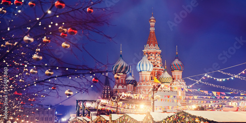 St. Basil Cathedral on Red Square in Moscow banner Russia, bokeh christmas light of lanterns on winter night