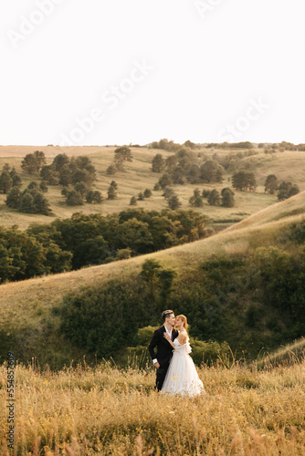 Wallpaper Mural Romantic couple in yellow tall grass against the backdrop of hills Torontodigital.ca