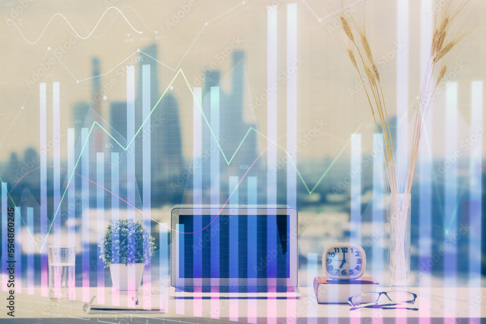 Forex Chart hologram on table with computer background. Double exposure. Concept of financial markets. Forex Chart hologram on table with computer background. Double exposure. Concept of financial markets.