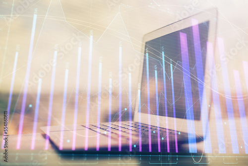 Fototapeta Naklejka Na Ścianę i Meble -  Stock market graph on background with desk and personal computer. Double exposure. Concept of financial analysis.