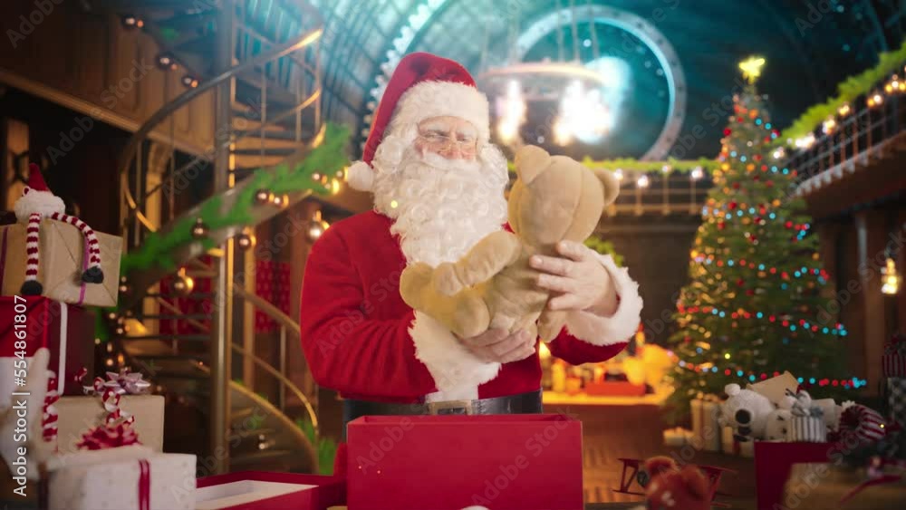 Jolly Santa Claus Works in His Studio Workshop, Wrapping and Packing Christmas Gifts for all the Good Children to be Delivered on the Magical New Year Eve. He Offers the Gift of Happines and Joy Jolly Santa Claus Works in His Studio Workshop, Wrapping and Packing Christmas Gifts for all the Good Children to be Delivered on the Magical New Year Eve. He Offers the Gift of Happines and Joy