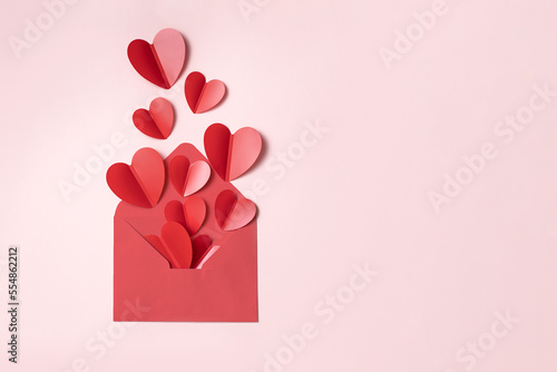 Valentine's day background with red and pink hearts like balloons on pink background, flat lay	
