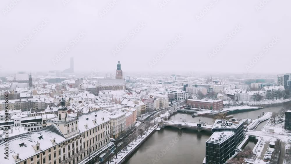Winter aerial view with snowfall on university and church near Odra river in center of Wroclaw 4k Winter aerial view with snowfall on university and church near Odra river in center of Wroclaw 4k