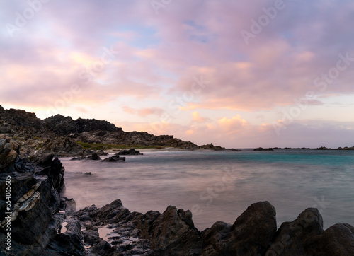 sunset seascape with rocks and reef at Capo Falcone in Sardinia