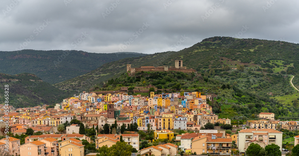 view of the colorful old town and Malaspina Castle of Bosa in the green mountains of Sardinia