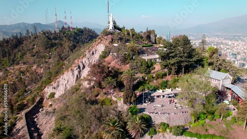 Aerial orbit of the virgin of cerro san cristobal and the bellavista terrace, tourist hill of Santiago, Chile. photo