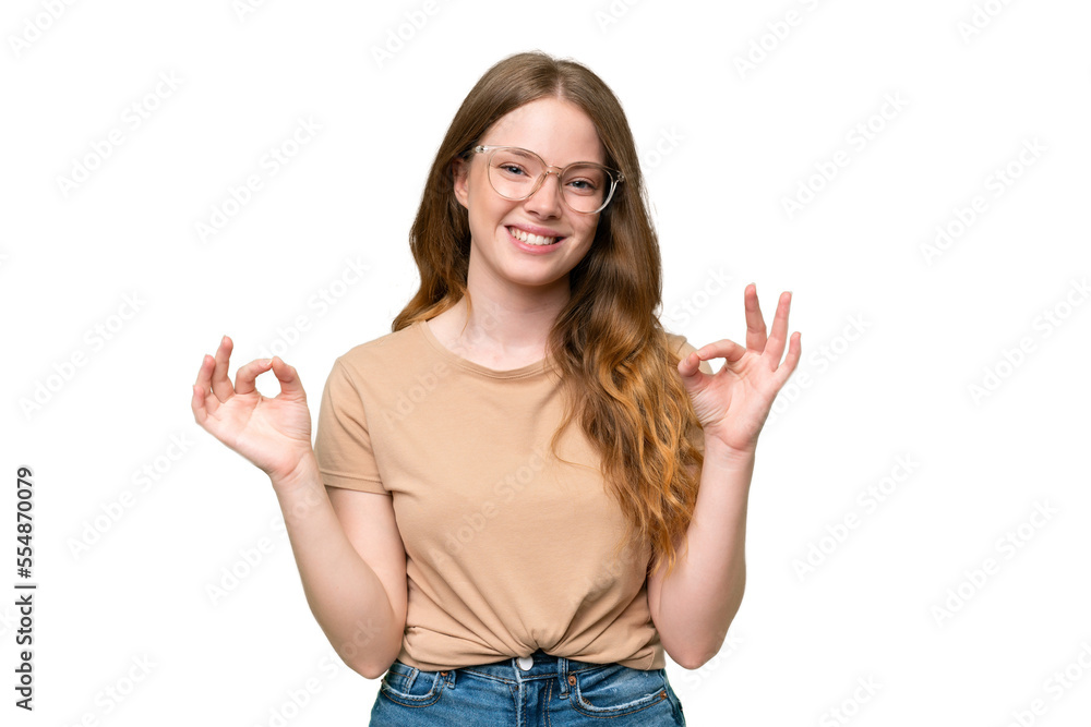 Young pretty woman over isolated background showing ok sign with two hands Young pretty woman over isolated background showing ok sign with two hands