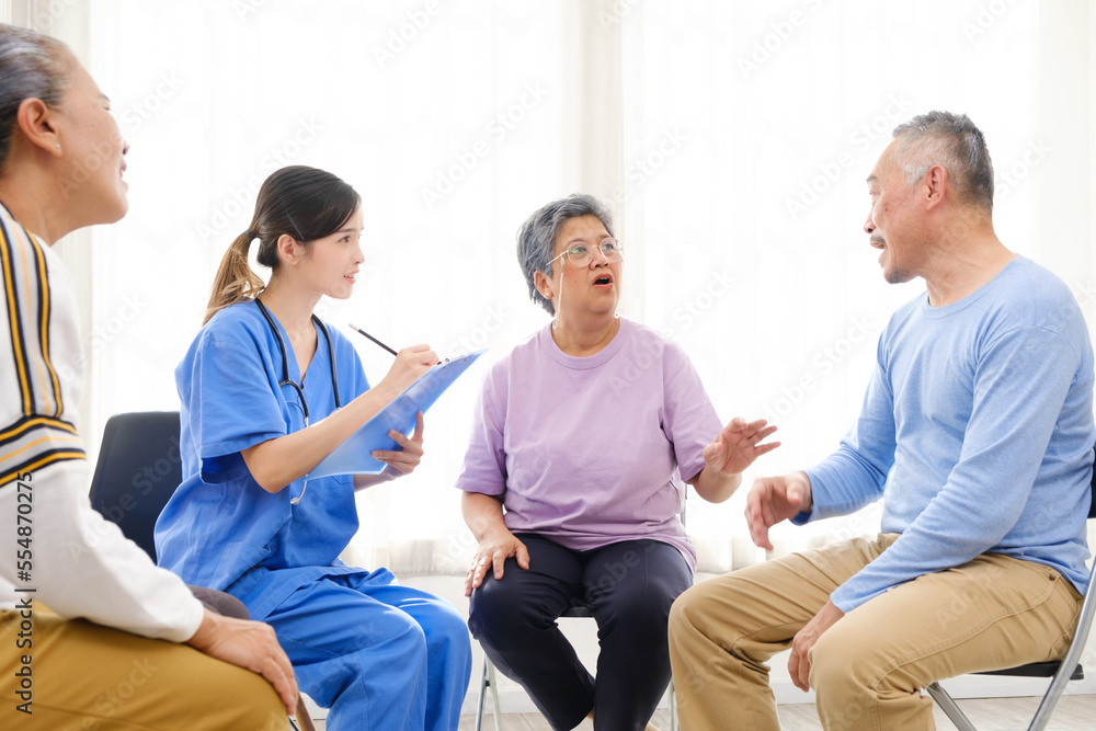 The caregiver therapist sits with a group of Asian senior people in a circle for checking physical and mental health in a group elderly therapy session. The nursing home facilitates a support group The caregiver therapist sits with a group of Asian senior people in a circle for checking physical and mental health in a group elderly therapy session. The nursing home facilitates a support group