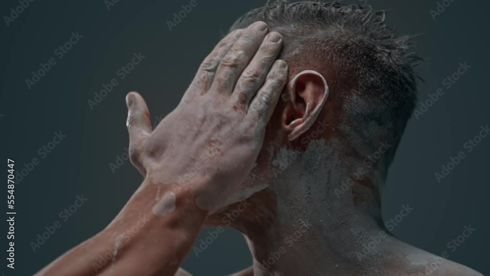 Video portrait of an athletic man with a naked torso runs his hand over his face Video portrait of an athletic man with a naked torso runs his hand over his face