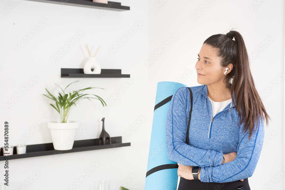 girl with fitness mat hanging, healthy and athletic ready to go for a workout girl with fitness mat hanging, healthy and athletic ready to go for a workout