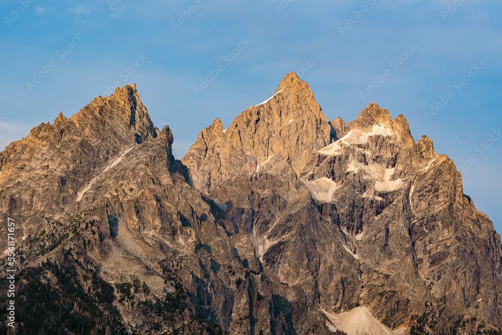 Sunlight Warms The Top of Grand Teton and The Remaining Snow In Summer