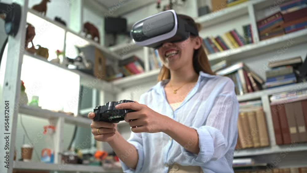 Pretty pretty woman wearing VR glasses. and joystick handle To play games at home with fun. Pretty pretty woman wearing VR glasses. and joystick handle To play games at home with fun.
