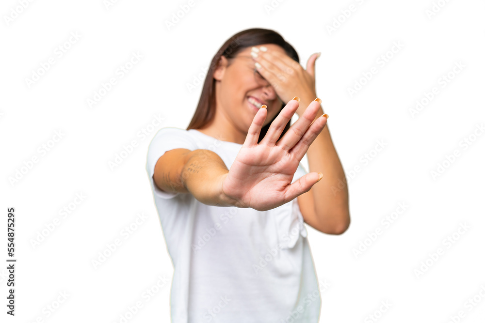 Young caucasian woman isolated on green chroma background making stop gesture and covering face Young caucasian woman isolated on green chroma background making stop gesture and covering face