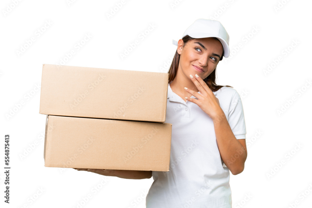 Delivery caucasian woman holding boxes isolated on green chroma background looking up while smiling Delivery caucasian woman holding boxes isolated on green chroma background looking up while smiling