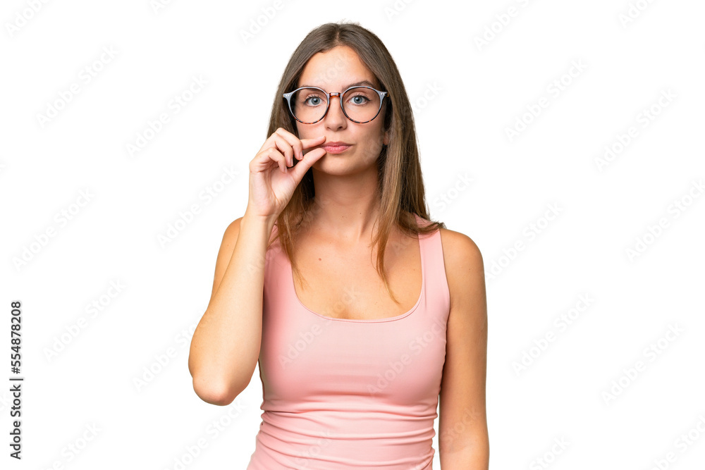 Young pretty woman over isolated background showing a sign of silence gesture