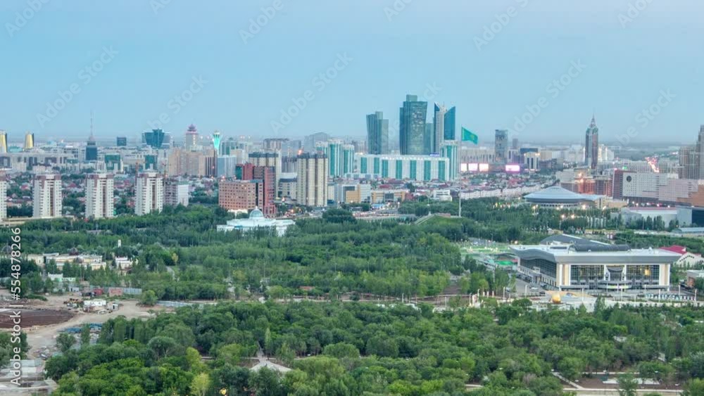 Elevated aerial view over the city center with river, bridge and park and central business district from day to night transition timelapse rooftop, Central Asia, Nur-Sultan city, Kazakhstan Elevated aerial view over the city center with river, bridge and park and central business district from day to night transition timelapse rooftop, Central Asia, Nur-Sultan city, Kazakhstan