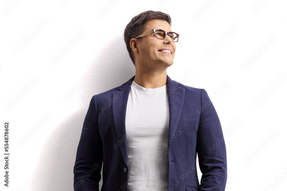 Young man leaning on a white wall and looking up Young man leaning on a white wall and looking up