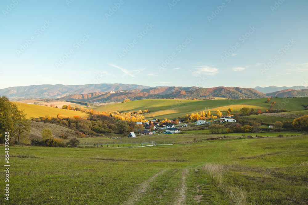 Sunset over the village of Lietava, Slovakia. Green hills with a view of Mala Fatra