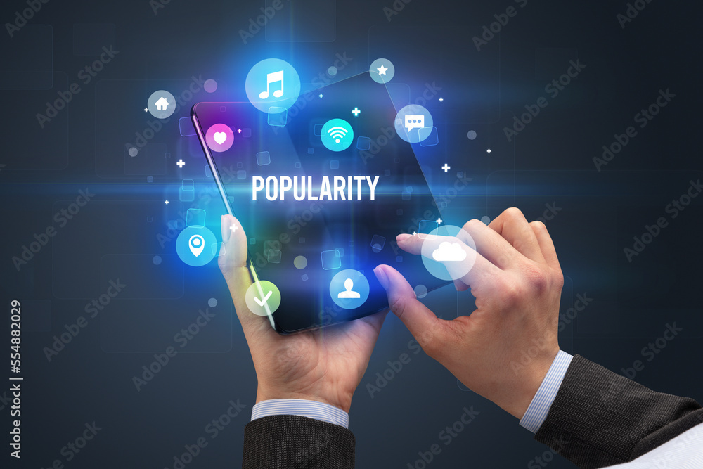 Businessman holding a foldable smartphone Businessman holding a foldable smartphone