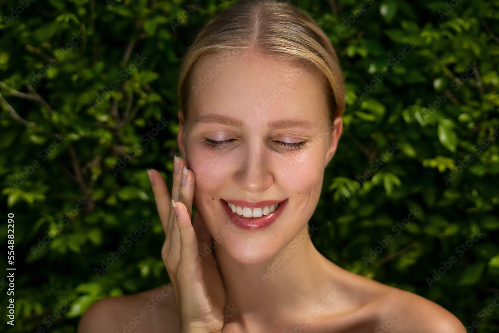 Natural skincare. Beauty blonde woman portrait against green leaves background. Organic cosmetic and skin treatments concept Natural skincare. Beauty blonde woman portrait against green leaves background. Organic cosmetic and skin treatments concept