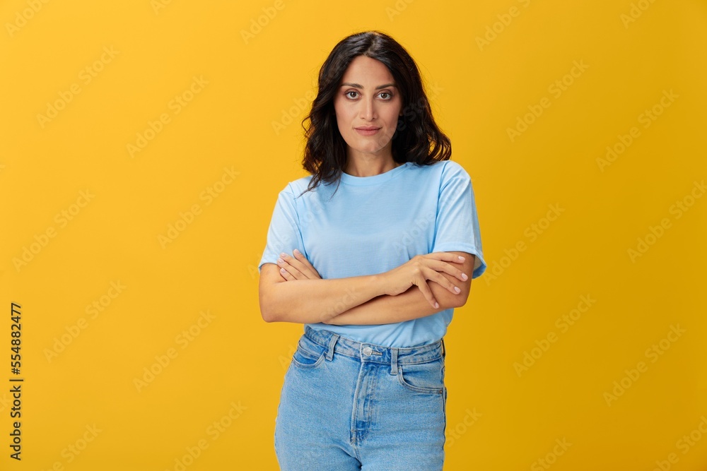 Woman signal smile with teeth emotion portrait in blue t-shirt on yellow background, hands up, surprise, lifestyle, copy space Woman signal smile with teeth emotion portrait in blue t-shirt on yellow background, hands up, surprise, lifestyle, copy space
