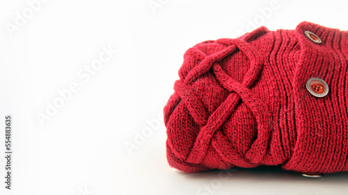 crimson wool knitted sweater with pigtail pattern, isolated on white background, copy space