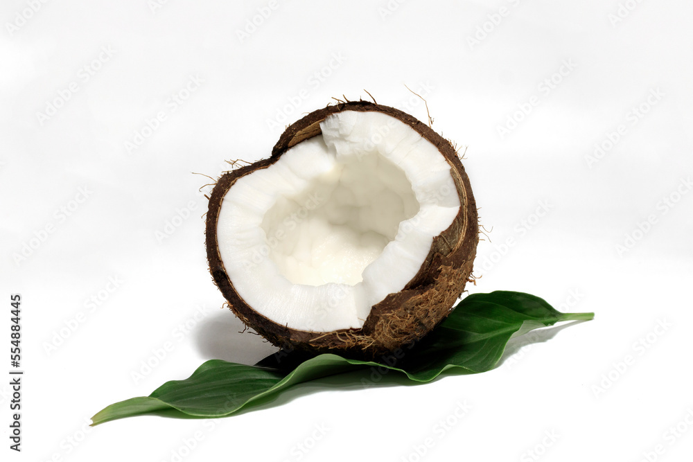 Coconut with half and leaves on white background Coconut with half and leaves on white background